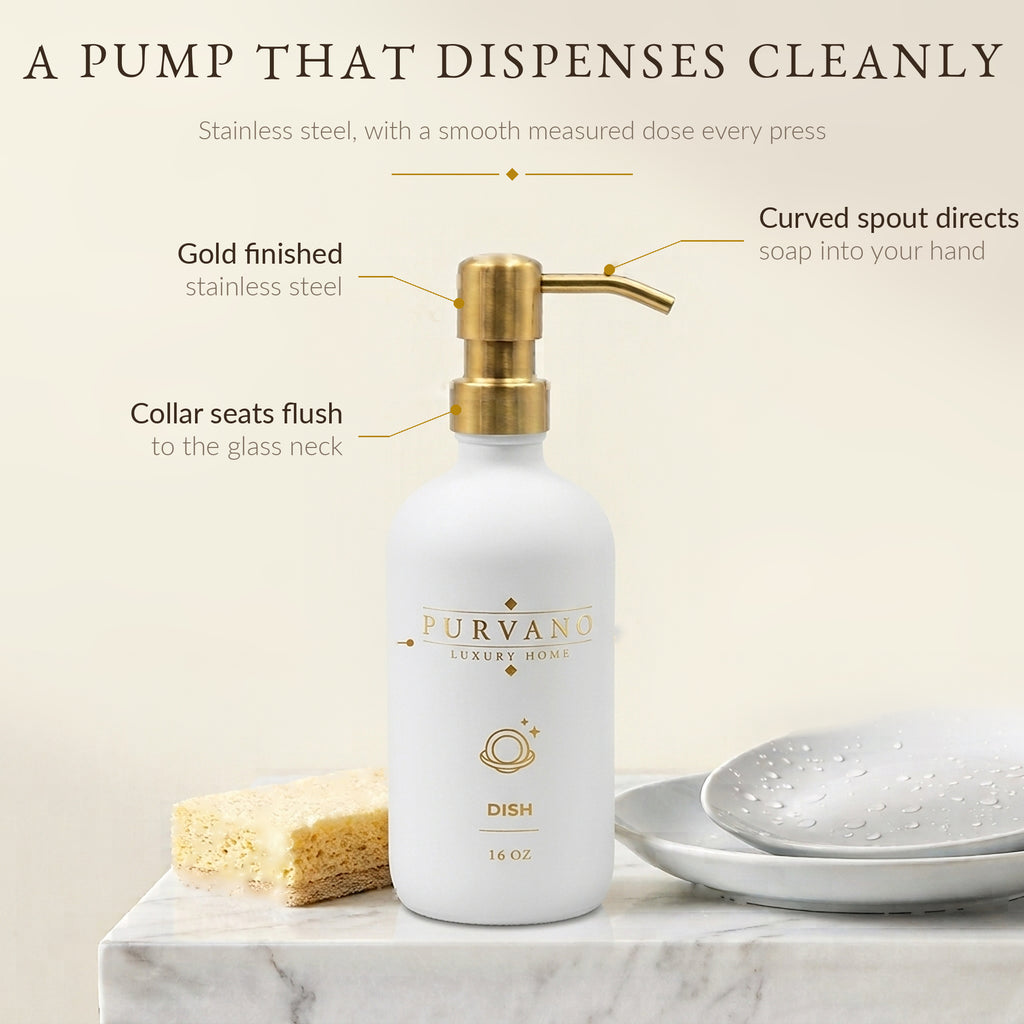 Brushed gold stainless steel pump with curved spout on a matte white glass bottle