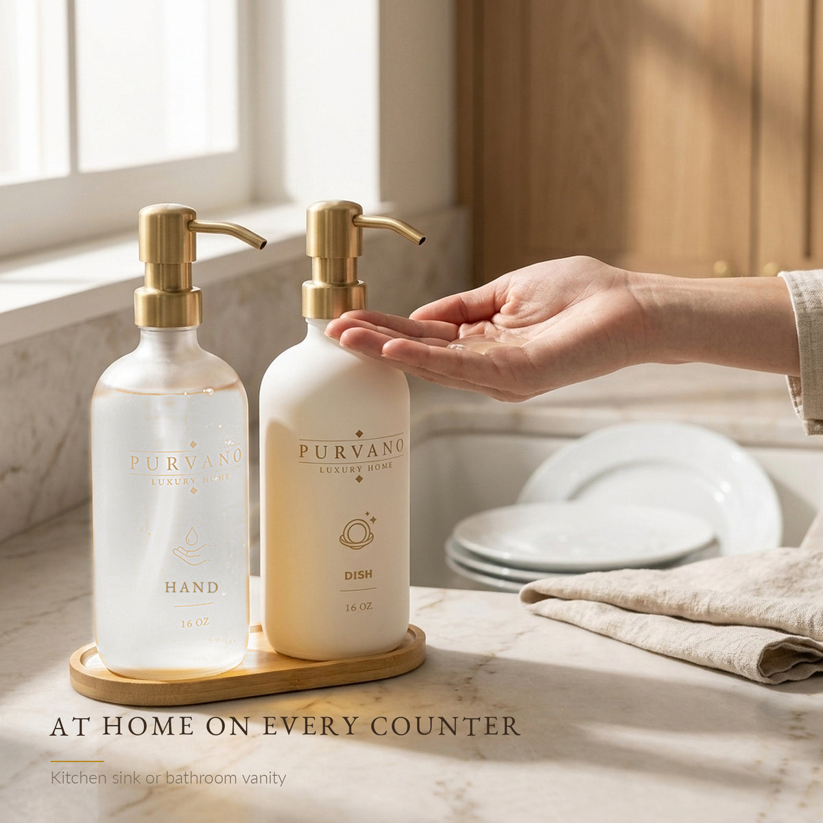 Frosted and matte white glass soap dispensers on a bathroom vanity beside a gold tap